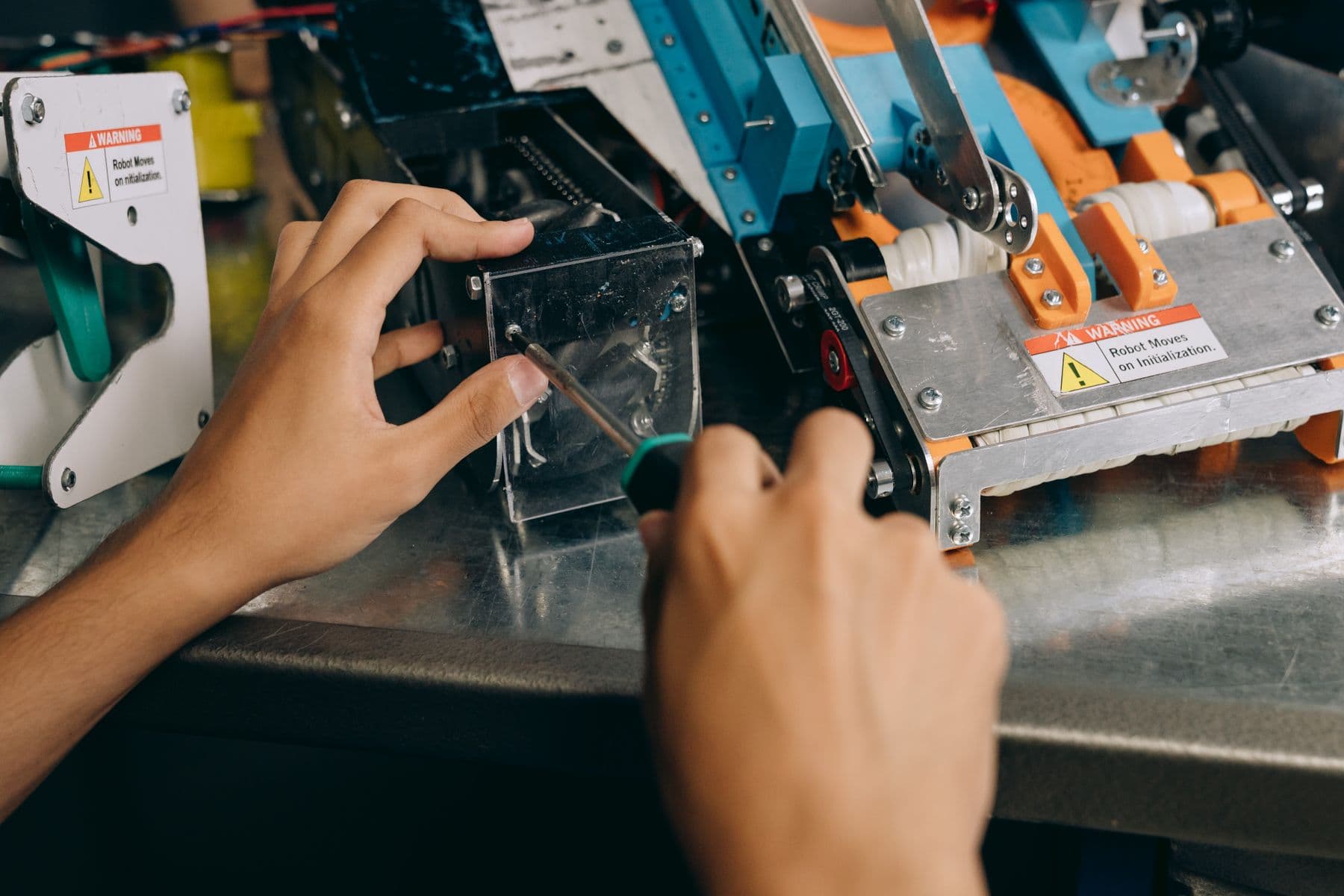 Technician servicing electromechanical components with hand tools