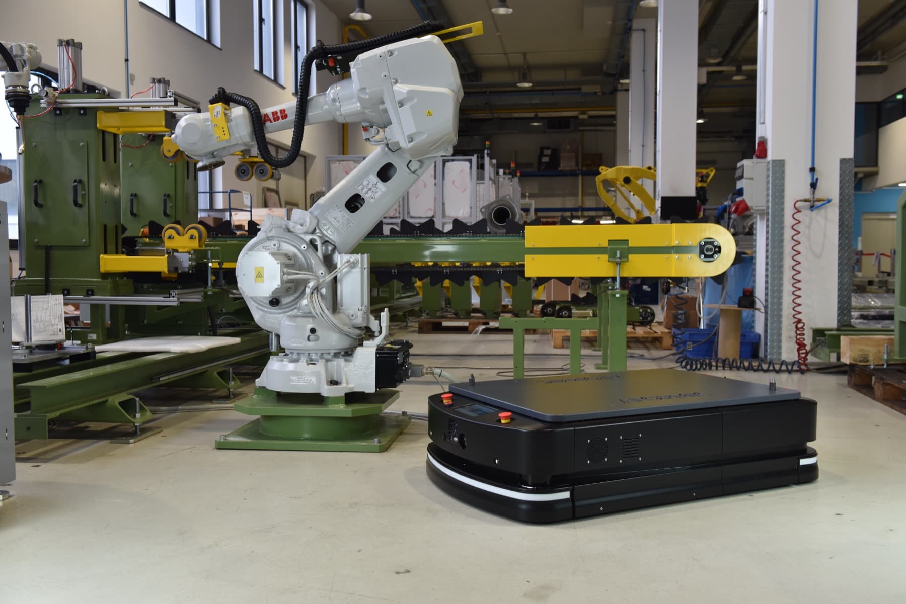 Autonomous mobile robot operating on the floor of an industrial facility